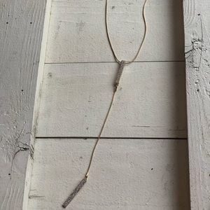 Long gold T style necklace